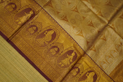 Close-up of a gold fabric with intricate patterns and designs.