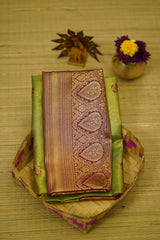 Traditional saree with intricate patterns on a wooden surface
