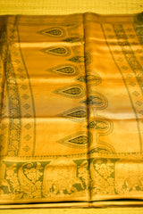 Yellow saree with green elephant and paisley patterns on a yellow background