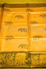 Yellow fabric with black elephant patterns on a green background