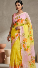 Woman wearing a colorful floral saree against a neutral background