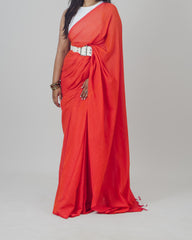 Person wearing a red saree with a white blouse on a gray background laaki.co