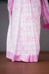 Pink and white checkered fabric with heart patterns on a dark background. laaki
