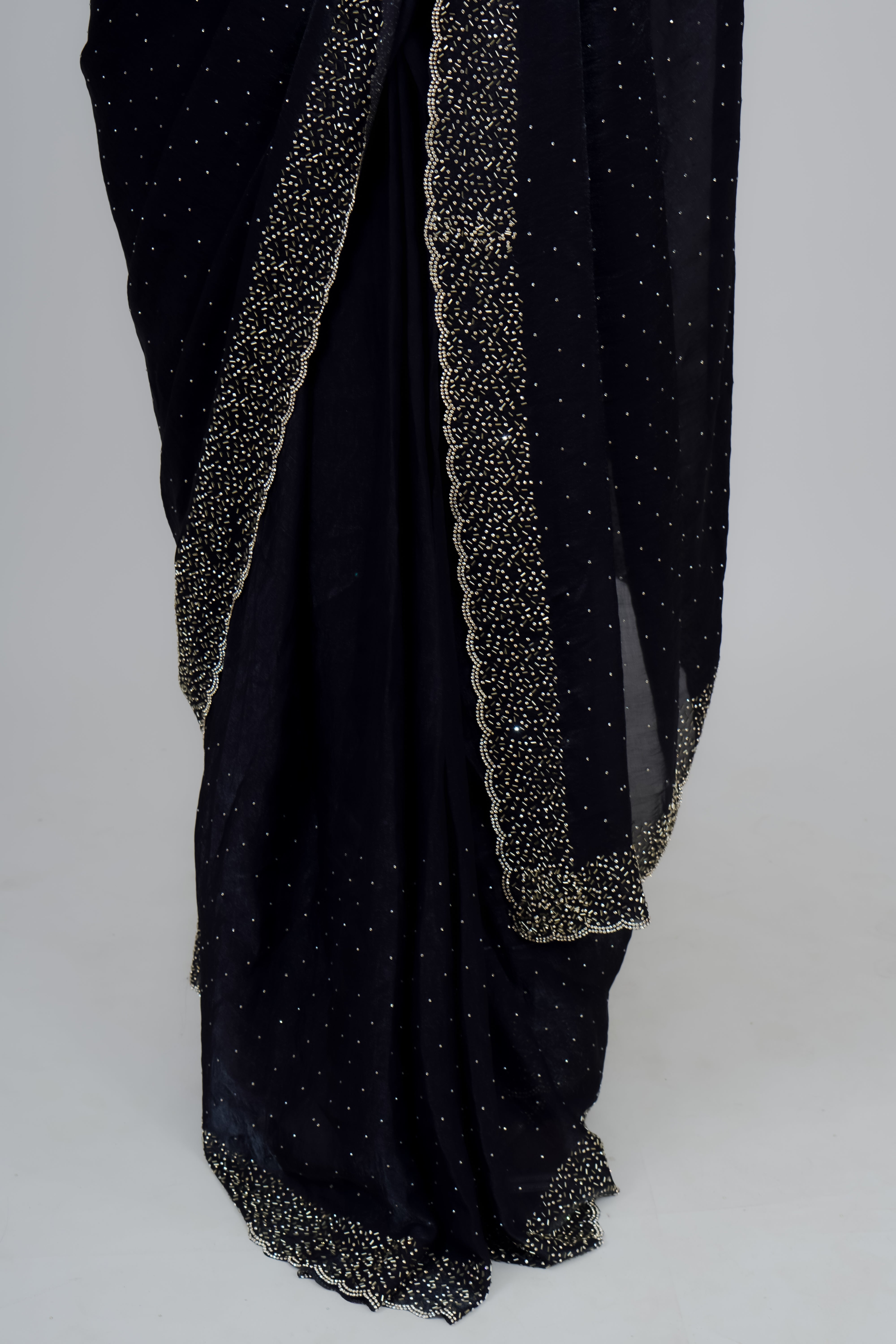 Black saree with silver border on a white background