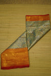 Two pieces of fabric with different patterns on a wooden surface