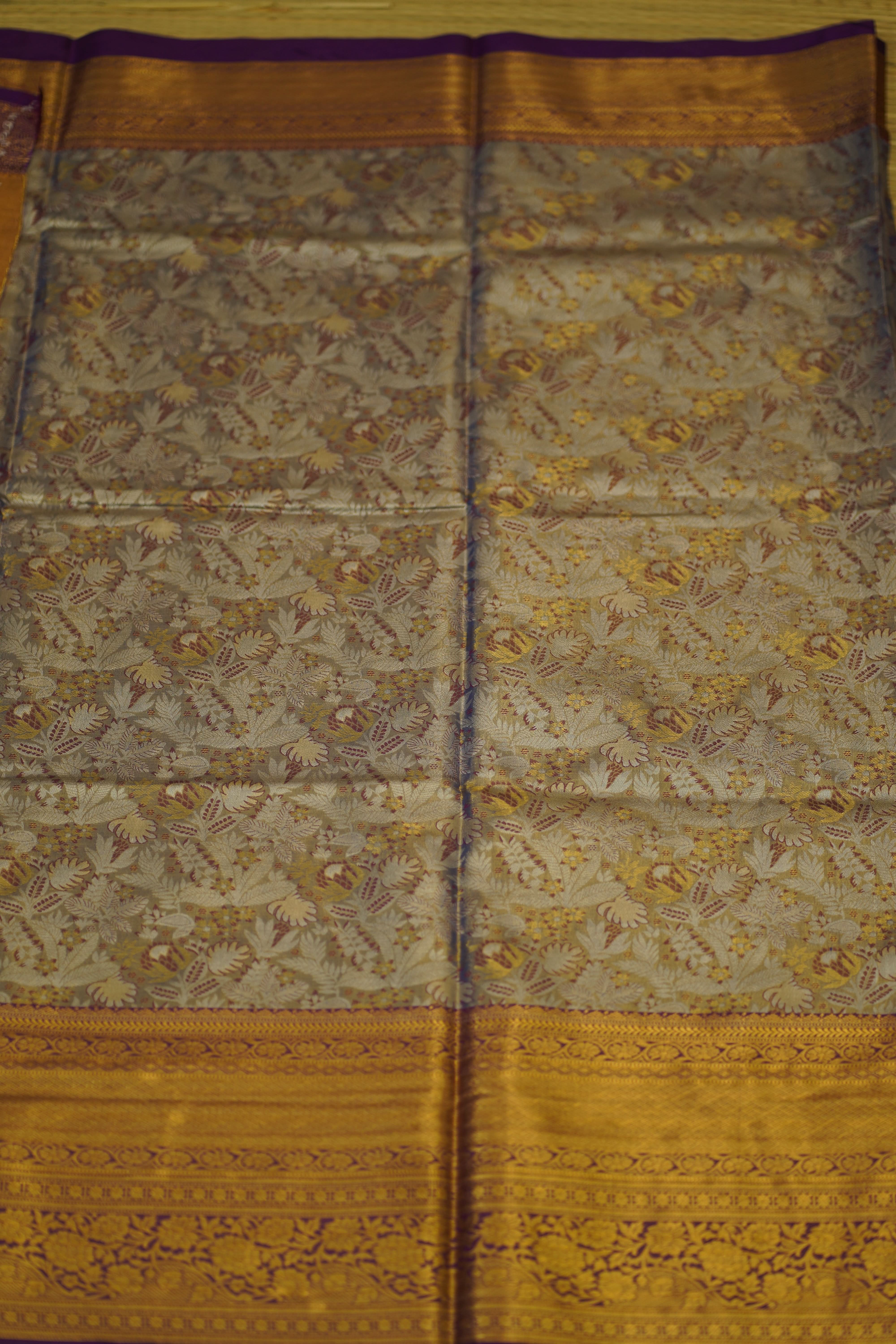 Decorative fabric with intricate patterns on a yellow and purple background