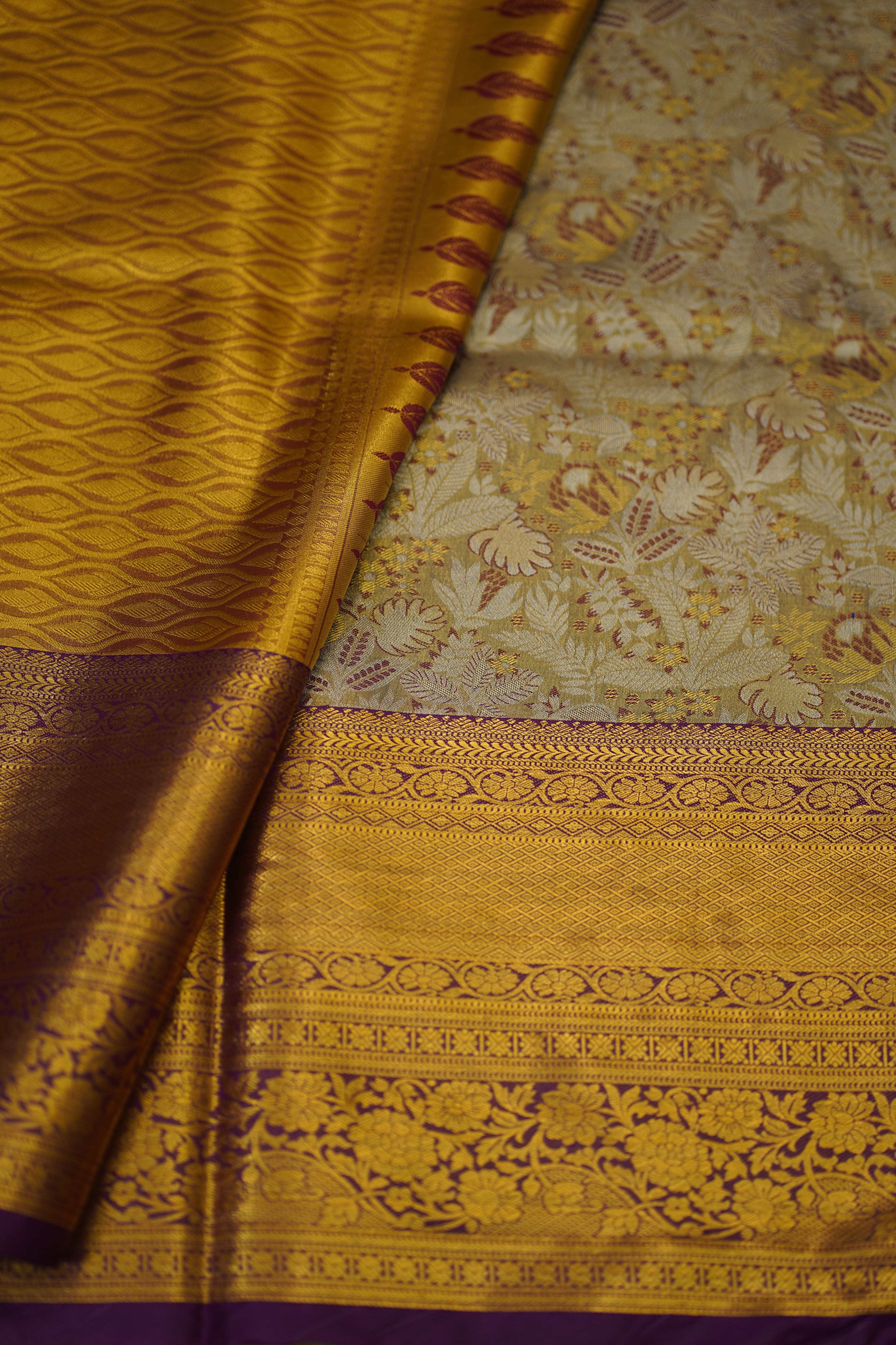 Close-up of a yellow fabric with intricate patterns and a purple background