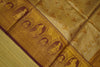 Close-up of a gold fabric with intricate patterns and designs.