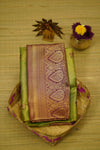 Traditional saree with intricate patterns on a wooden surface