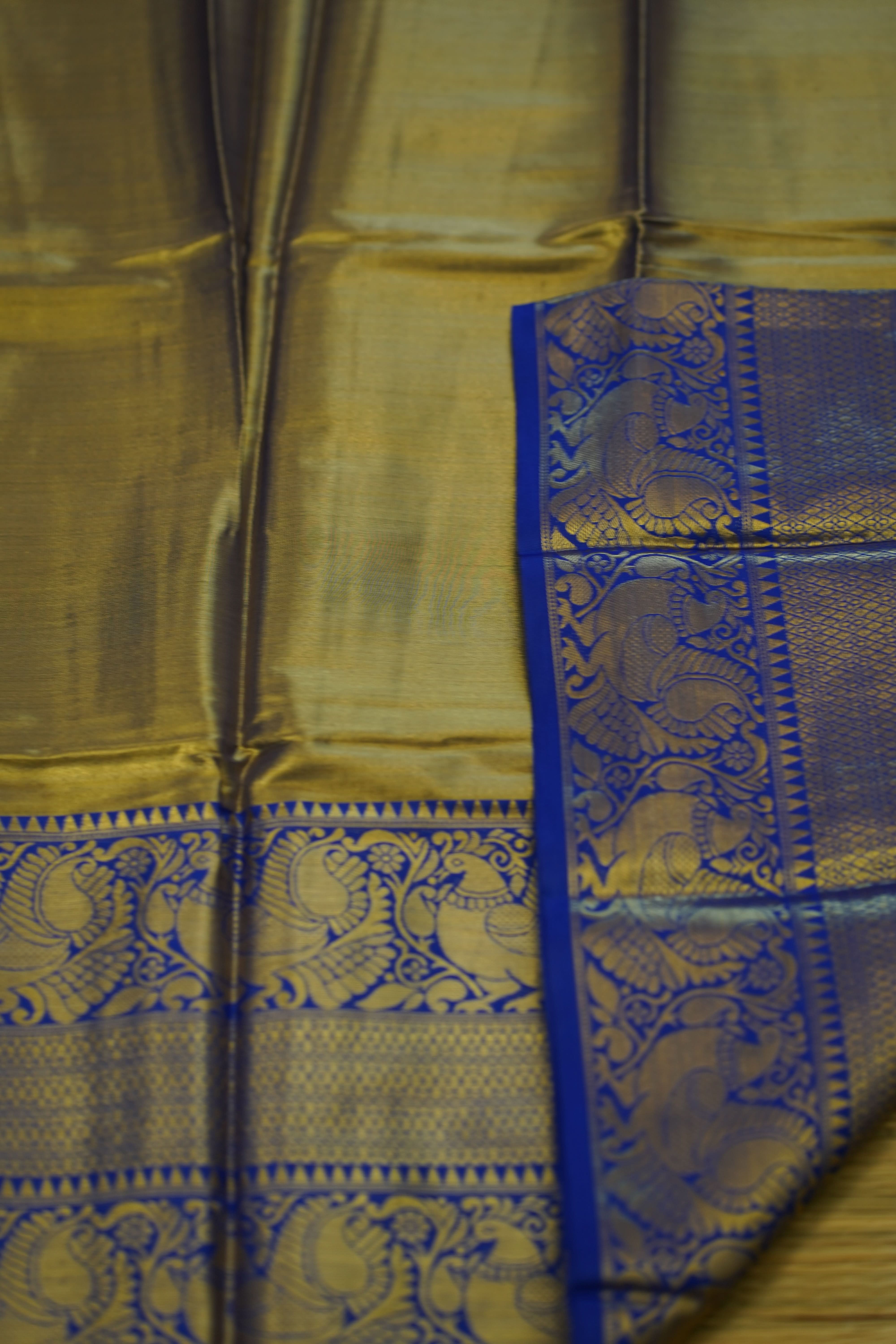 Gold fabric with blue border featuring elephant patterns