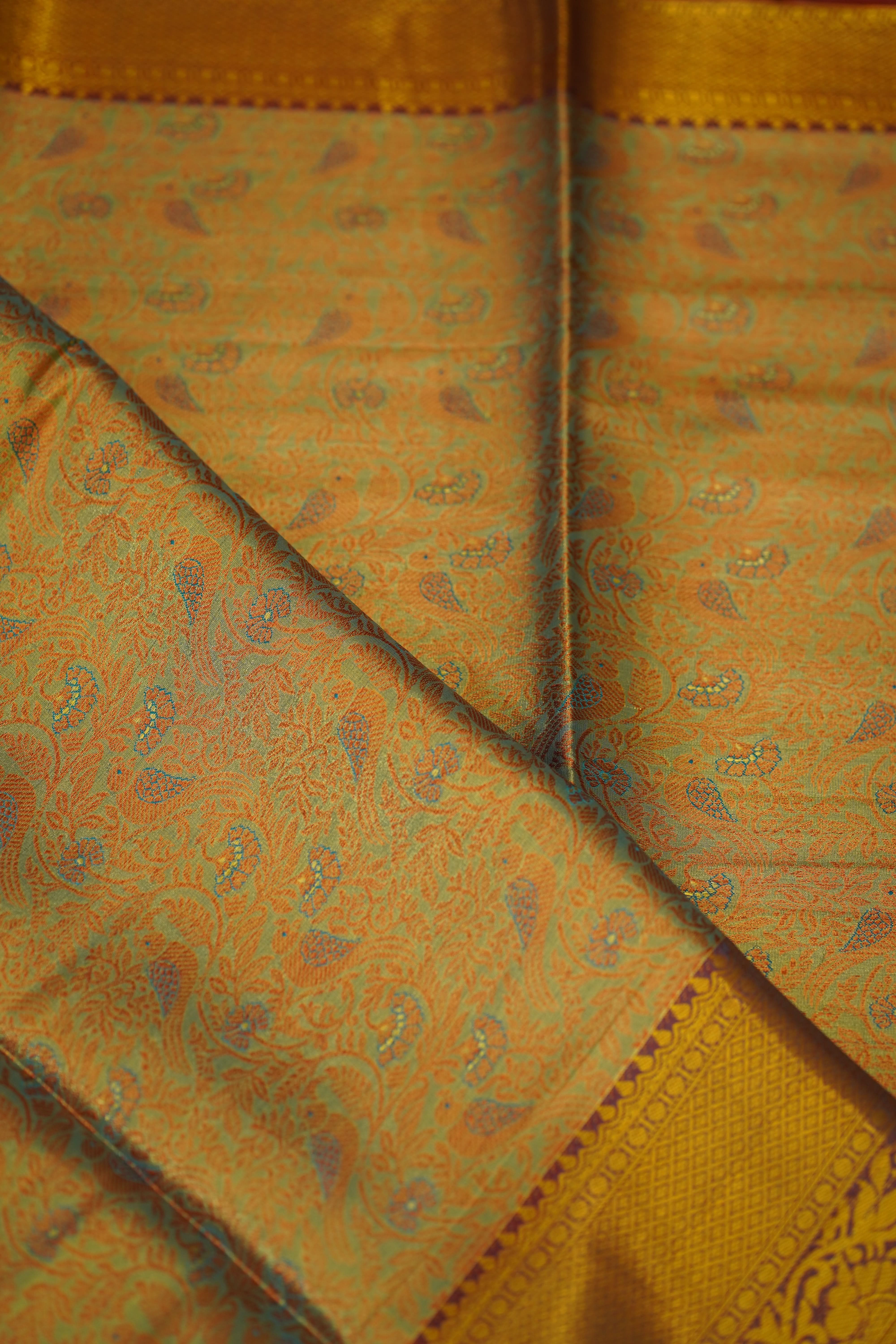 Close-up of a patterned fabric with gold and brown colors