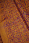 Close-up of orange fabric with intricate purple and green patterns