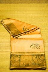 Folded traditional fabric with elephant design on a yellow textured background