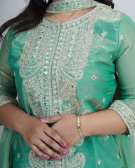 Green embroidered traditional outfit with close-up of intricate design www.laaki.co