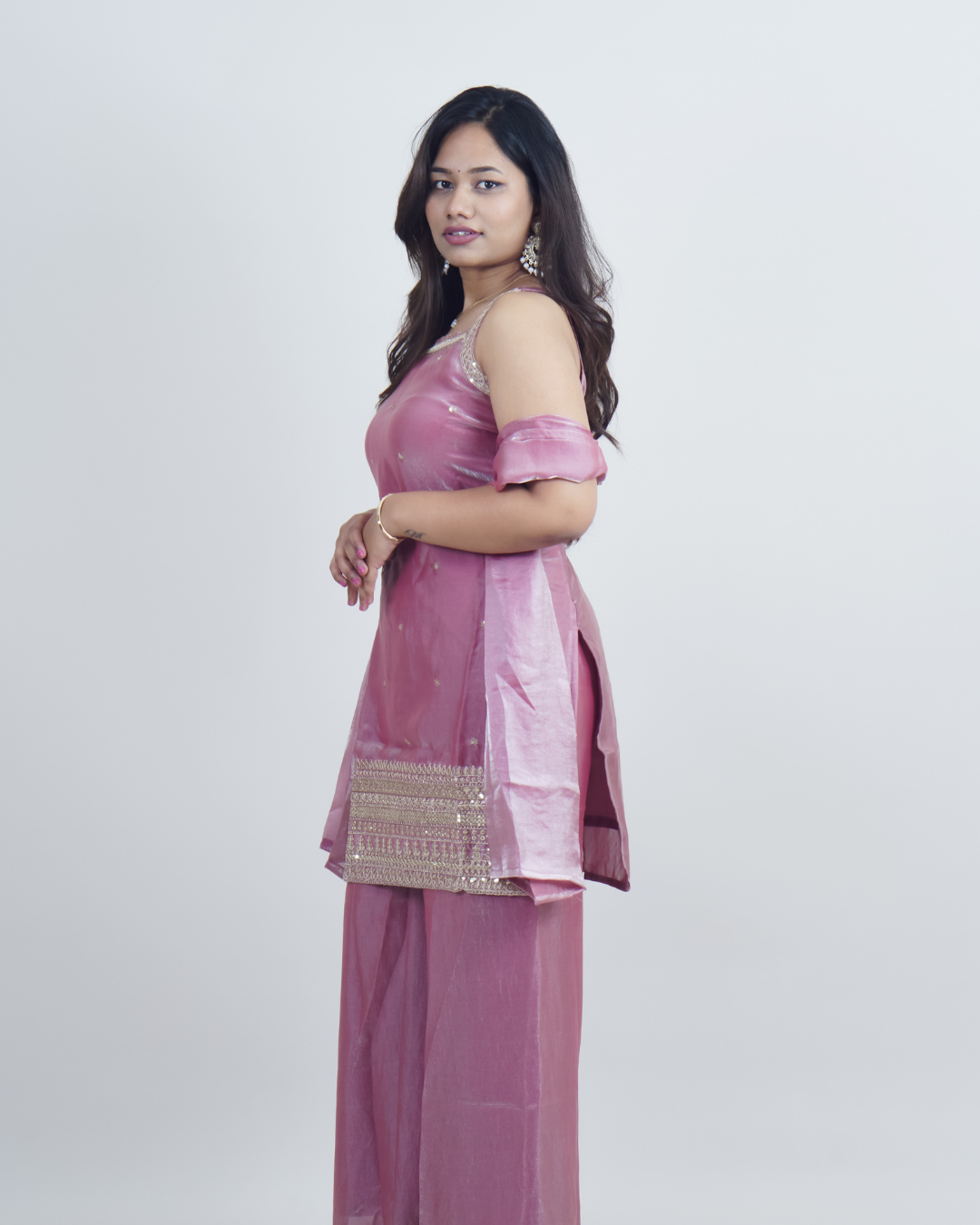 Woman wearing a pink traditional outfit with a white background