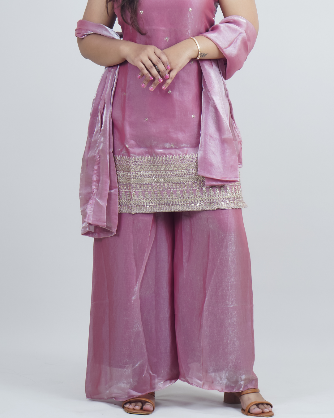 Pink traditional outfit with a dupatta on a white background