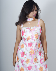 Woman wearing a floral dress against a plain background www.laaki.co