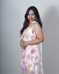 Woman wearing a floral dress against a plain background www.laaki.co