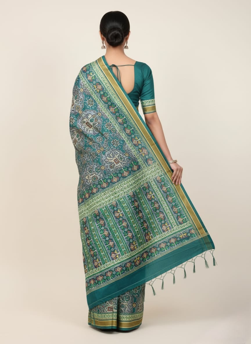 Woman wearing a green saree with a pattern on a beige background