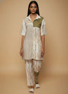 laaki Woman wearing a patterned outfit on a beige background