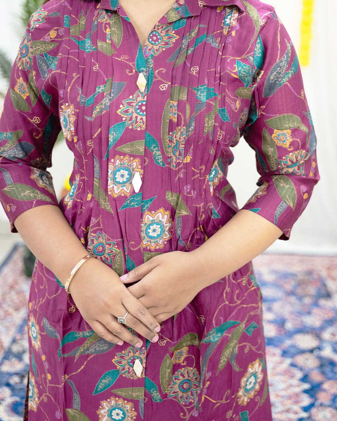 Purple floral patterned dress worn by a person. laaki