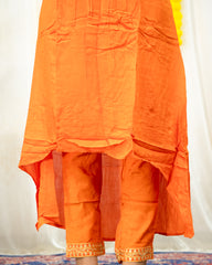 laaki Orange traditional outfit with a plain background