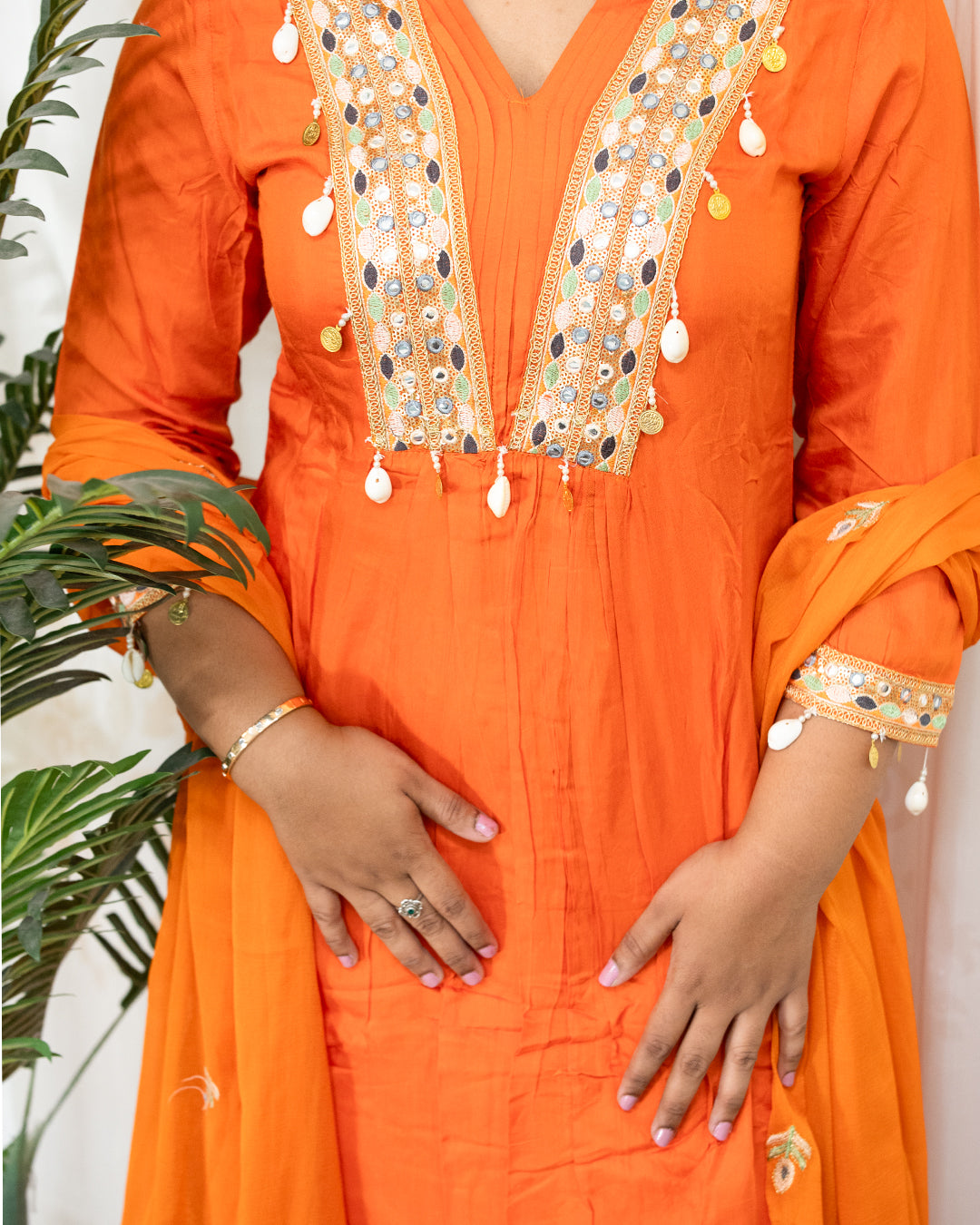 laaki Orange traditional outfit with intricate embroidery and embellishments.