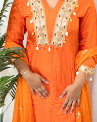 laaki Orange traditional outfit with intricate embroidery and embellishments.
