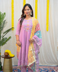 laaki Woman wearing a colorful traditional outfit with a decorative background
