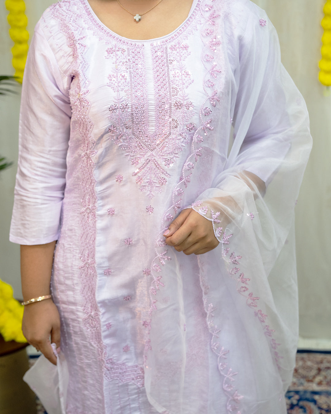 White embroidered kurta with a sheer dupatta worn by a person indoors. www.laaki.co
